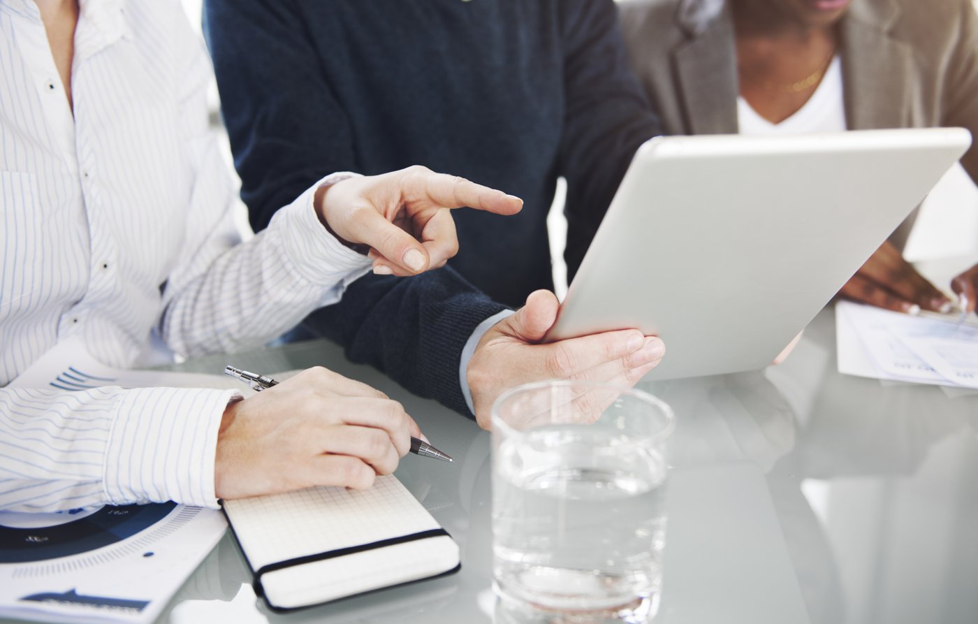Business leaders reviewing findings together on a tablet